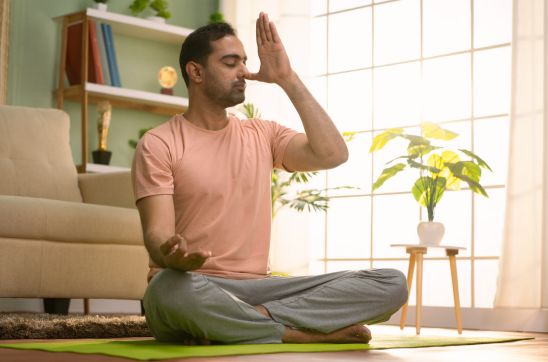 man doing nostril breathing or Yoga